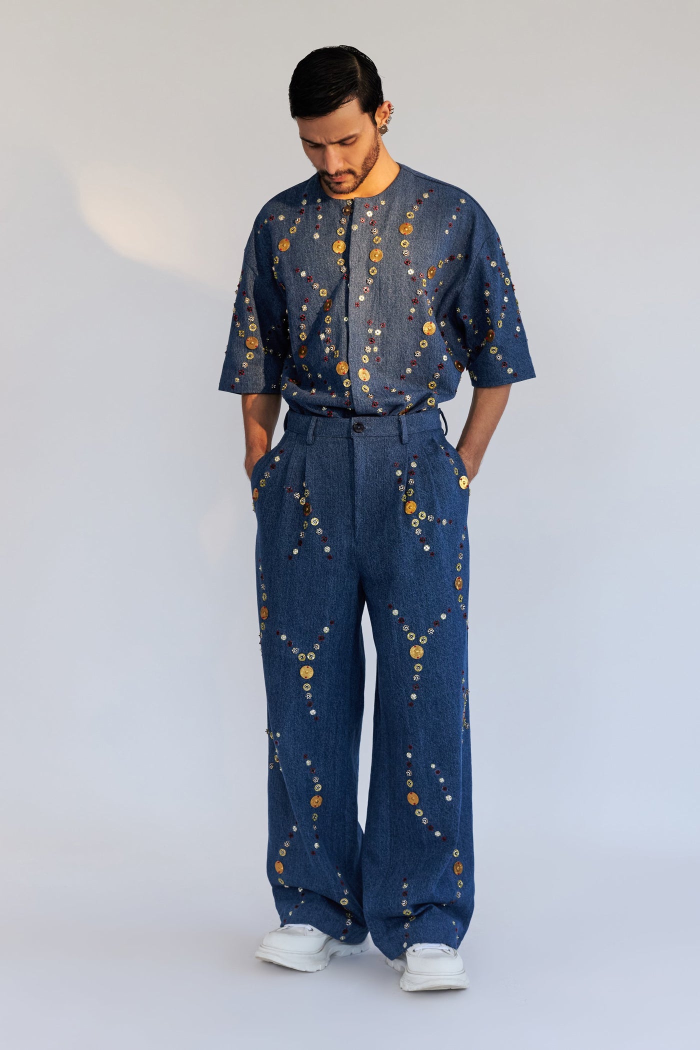 ROSANI The Enzo trouser, three-quarter view. Wide-leg silhouette and front pleat construction.