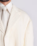 ROSANI The Jesse blazer in eggshell, three-quarter view. All-over pleat construction with wide shoulder silhouette.