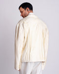 ROSANI The Jesse blazer in eggshell, back view. Full-body pleating detail. ANIMA and ANIMUS collection.
