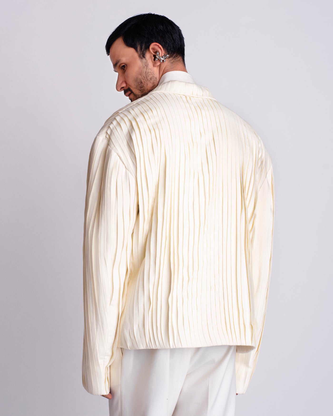 ROSANI The Jesse blazer in eggshell, back view. Full-body pleating detail. ANIMA and ANIMUS collection.