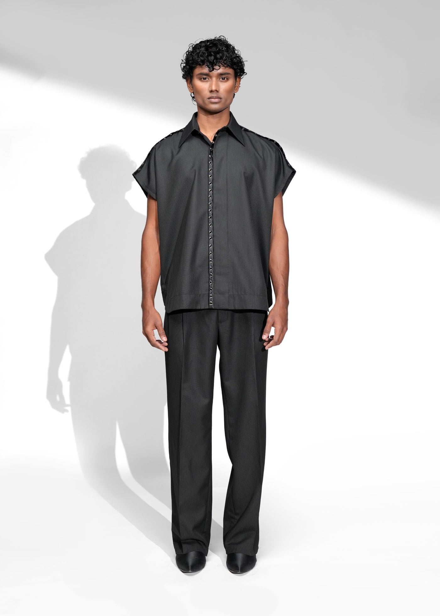ROSANI The Ease shirt in black - sleeveless pinstripe shirt with satin metallic eyelet placket detail, front view