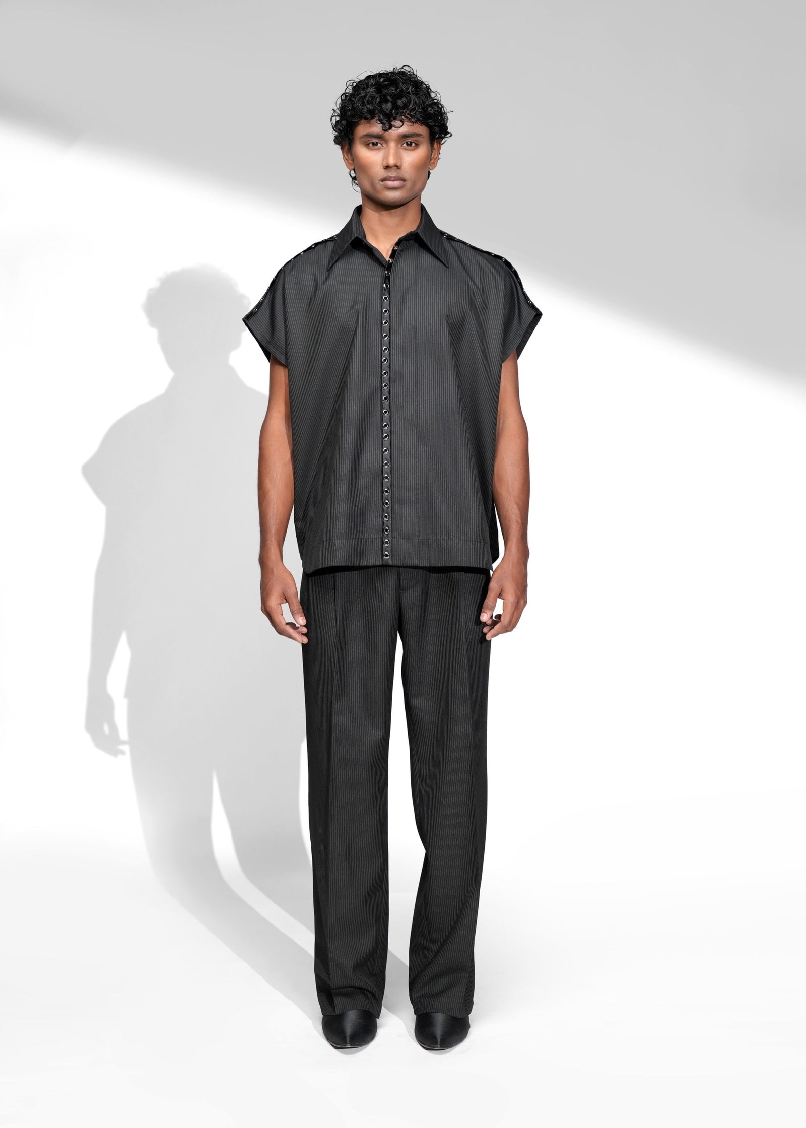 ROSANI The Ease shirt in black - sleeveless pinstripe shirt with satin metallic eyelet placket detail, front view