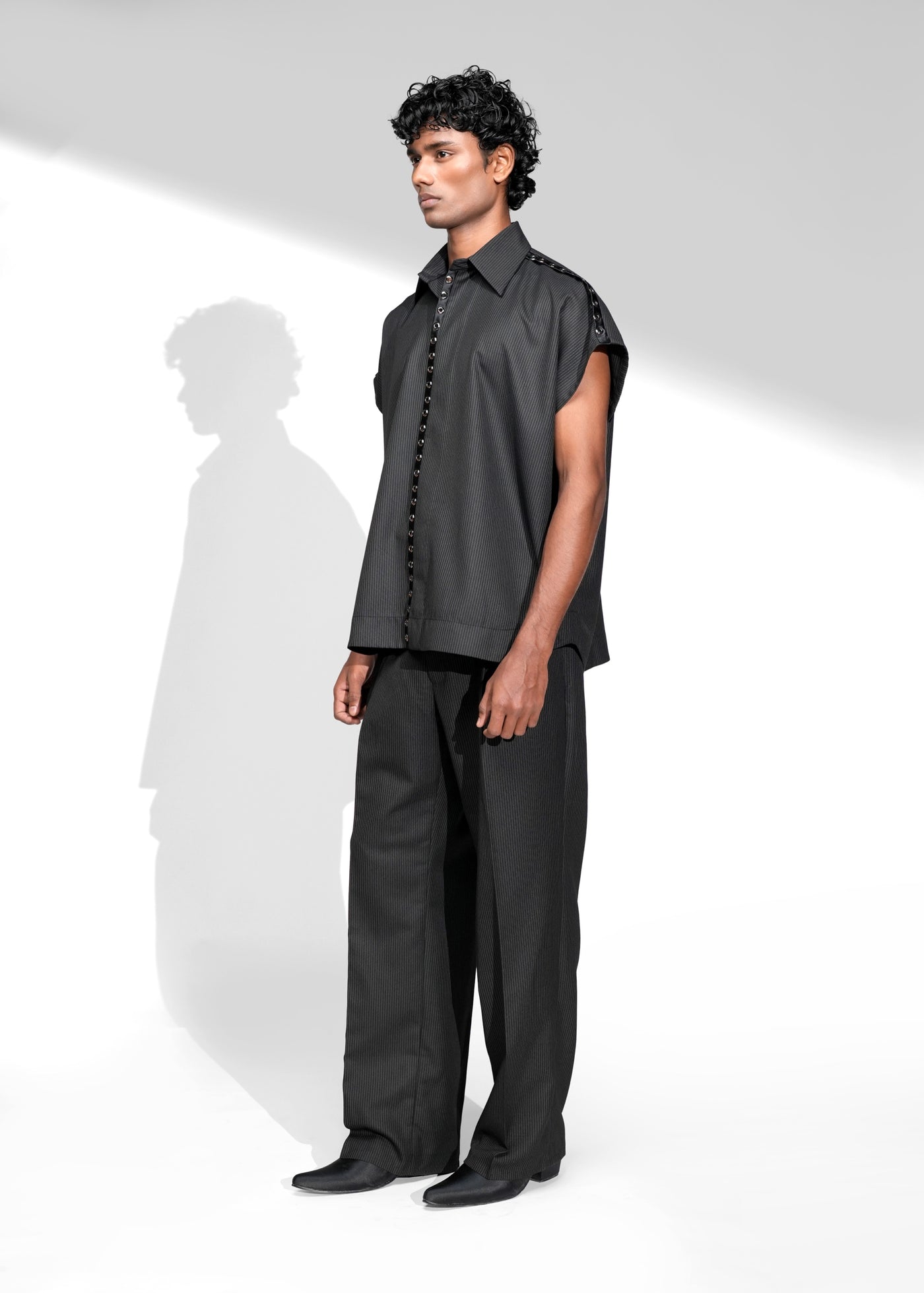 ROSANI The Ease shirt in black - metallic eyelet detail on placket and shoulder, close-up