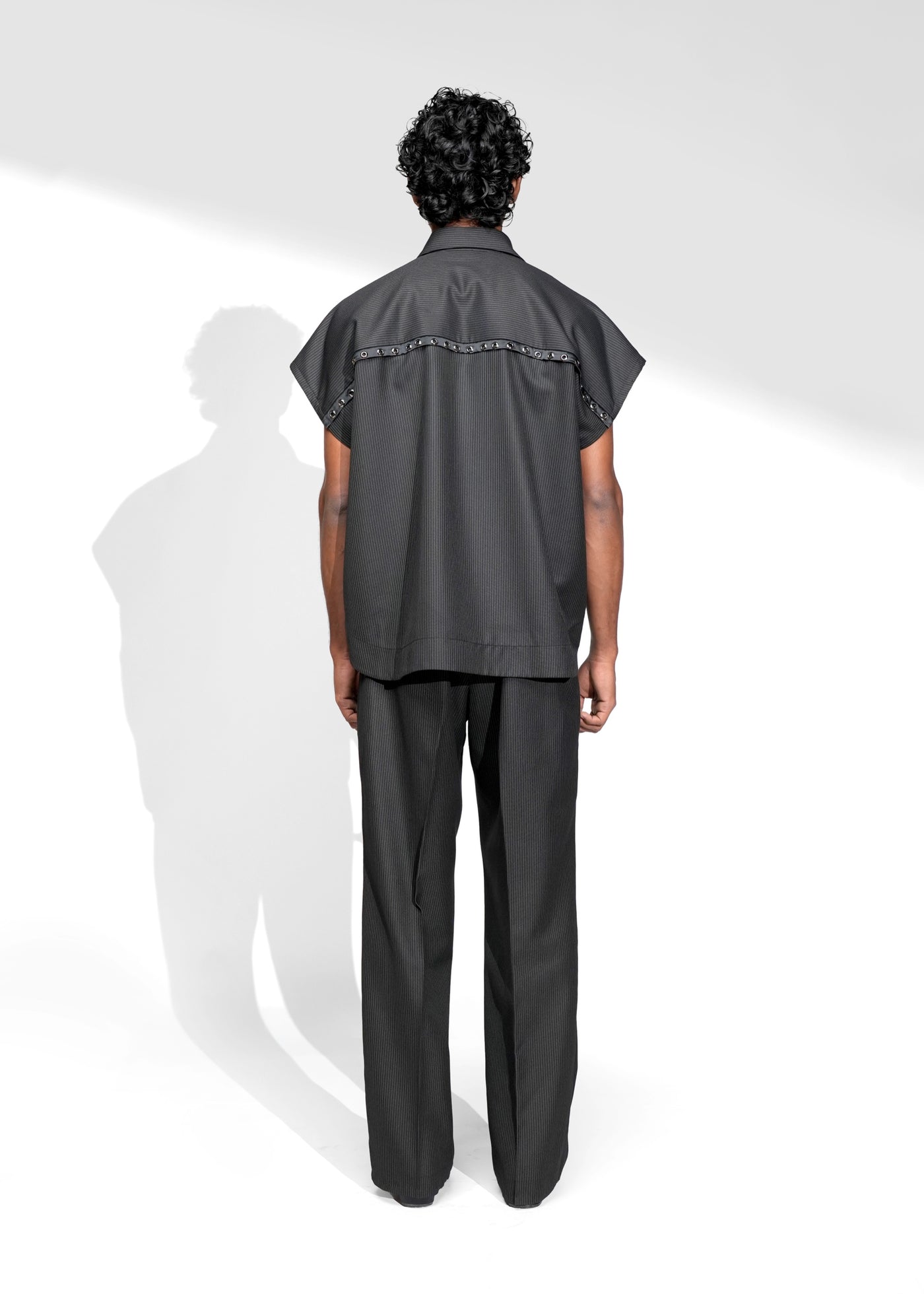 ROSANI The Ease shirt in black - sleeveless pinstripe shirt with metallic eyelet detail, front side view