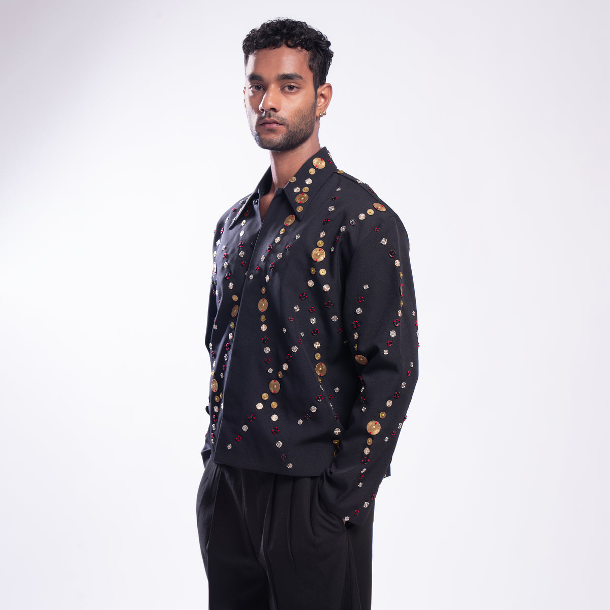 ROSANI The Ameus jacket, close-up of overlapping brass discs and metallic embroidery threads.