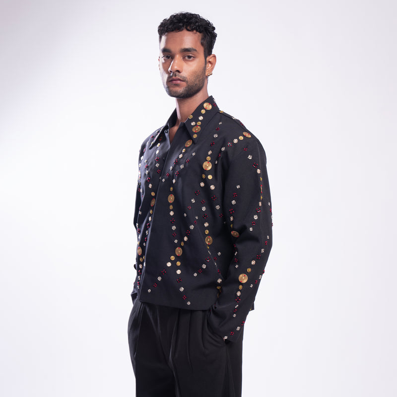 ROSANI The Ameus jacket, close-up of overlapping brass discs and metallic embroidery threads.