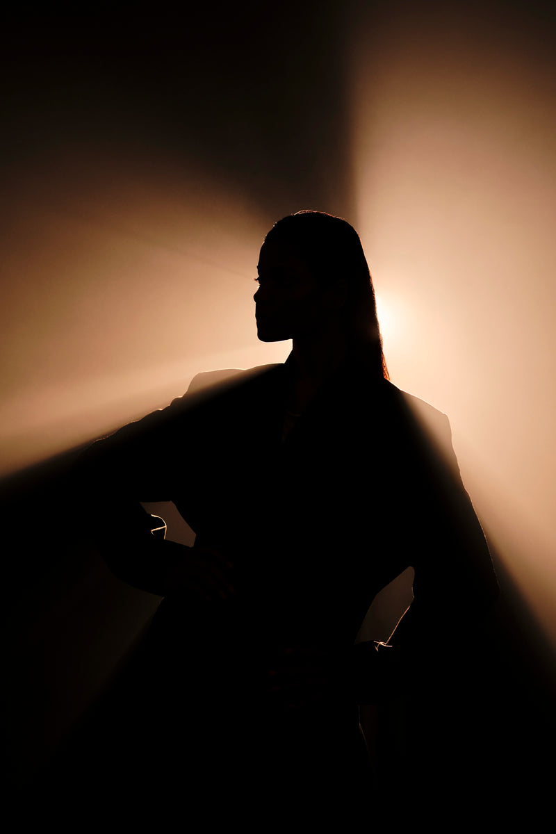 Club ROSANI campaign - backlit silhouette in warm glow, evoking a judgement-free sanctuary to be yourself and live in the moment