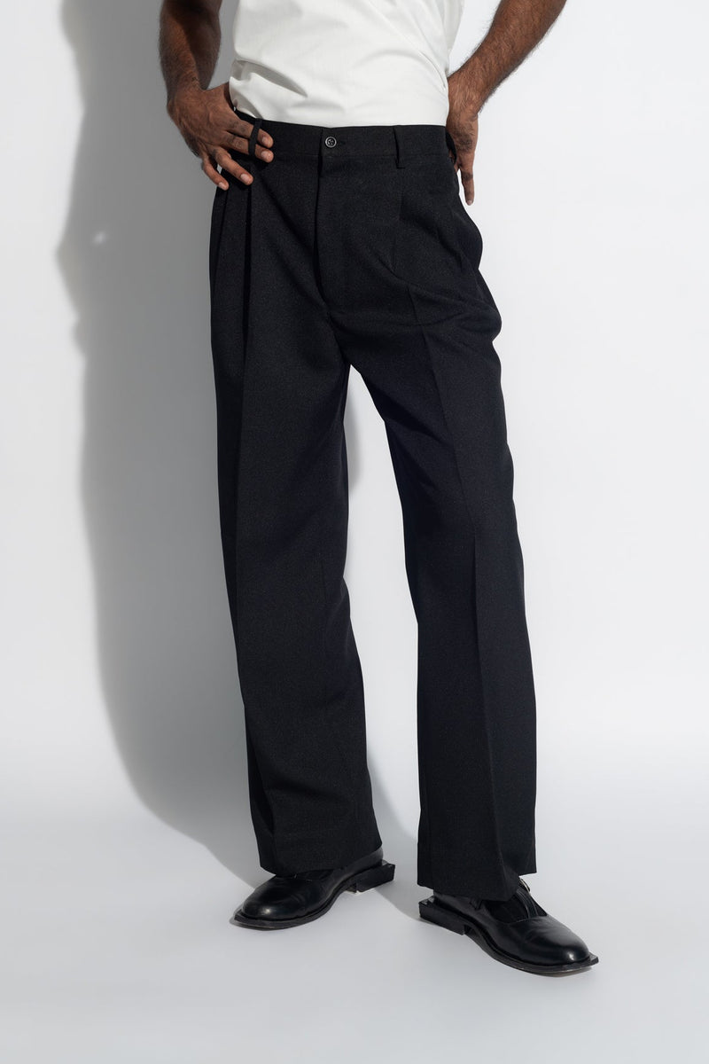 ROSANI The Ankathi trouser in black - relaxed wide-leg tailored trousers with front pleats and elastic back waistband, front view, styled with a white top