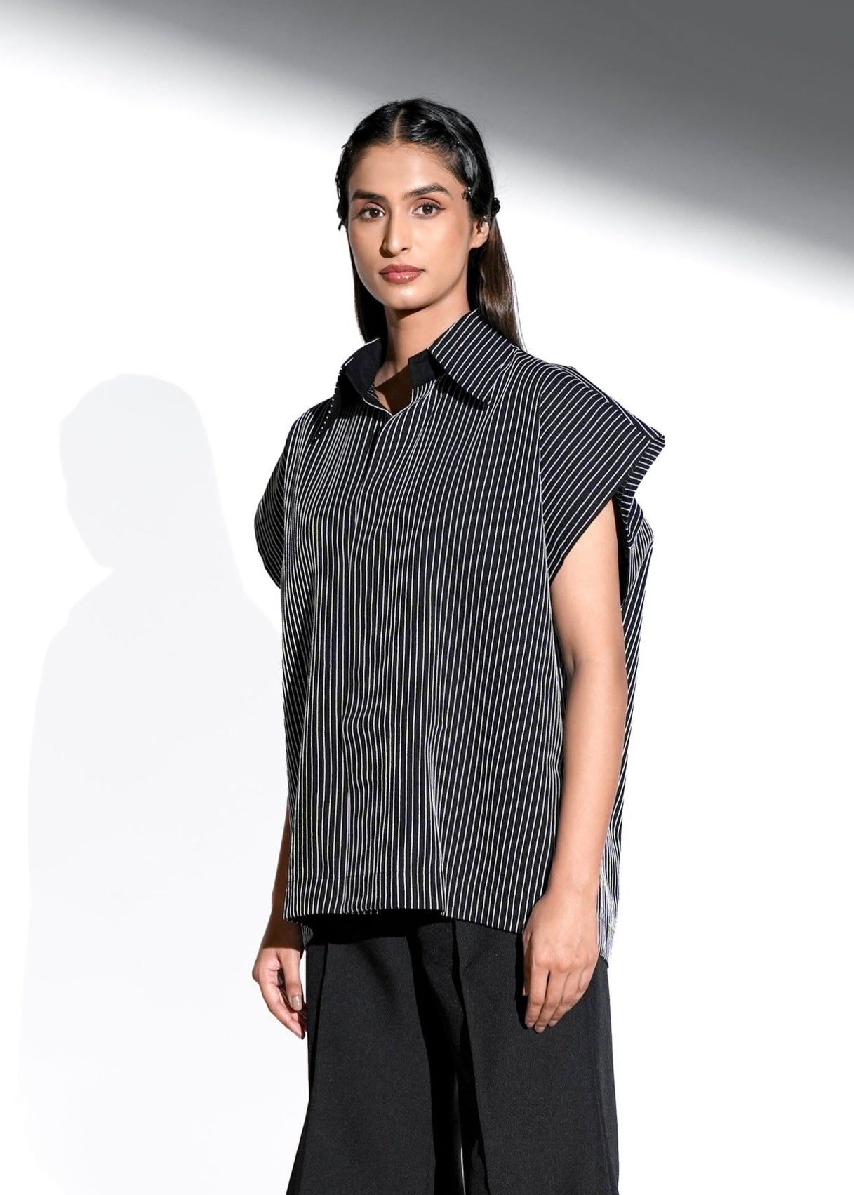 ROSANI The Auralis shirt in black - oversized sleeveless collared shirt with fine hand embroidered vertical stripes and clean straight hem, front side view