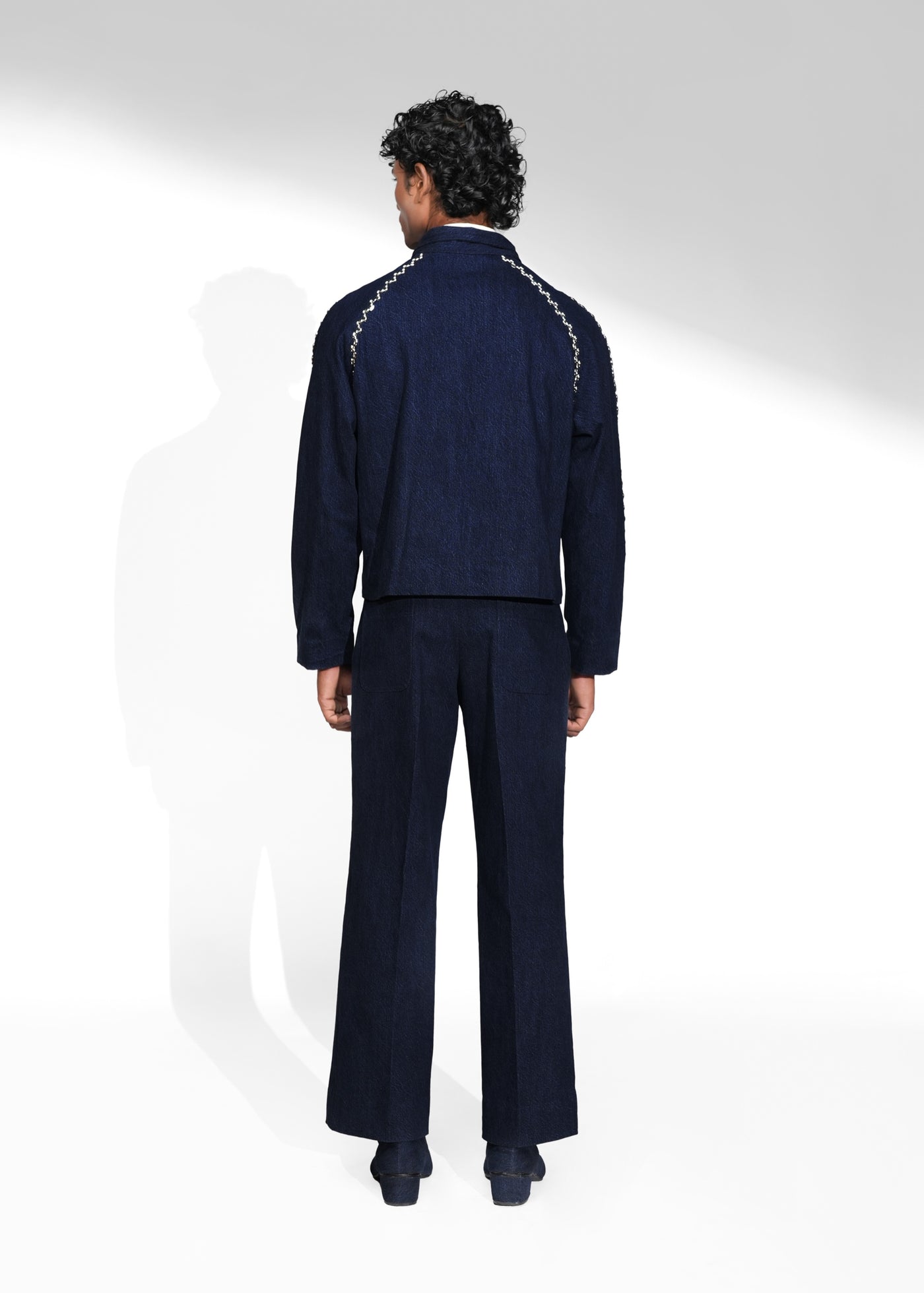 ROSANI The Cloister jacket in midnight denim - cropped raglan-sleeve jacket with metallic seam accents, back view