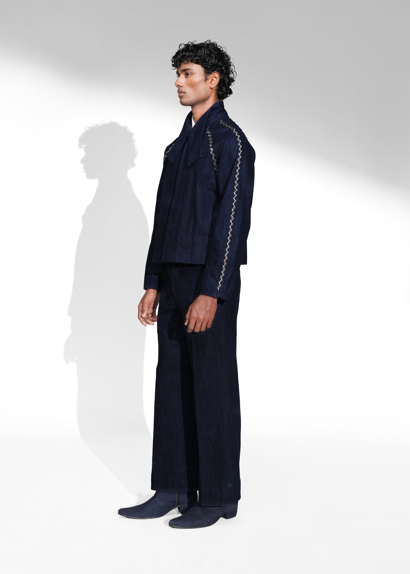 ROSANI The Cloister jacket in midnight denim - cropped raglan-sleeve jacket with metallic seam accents, front side view