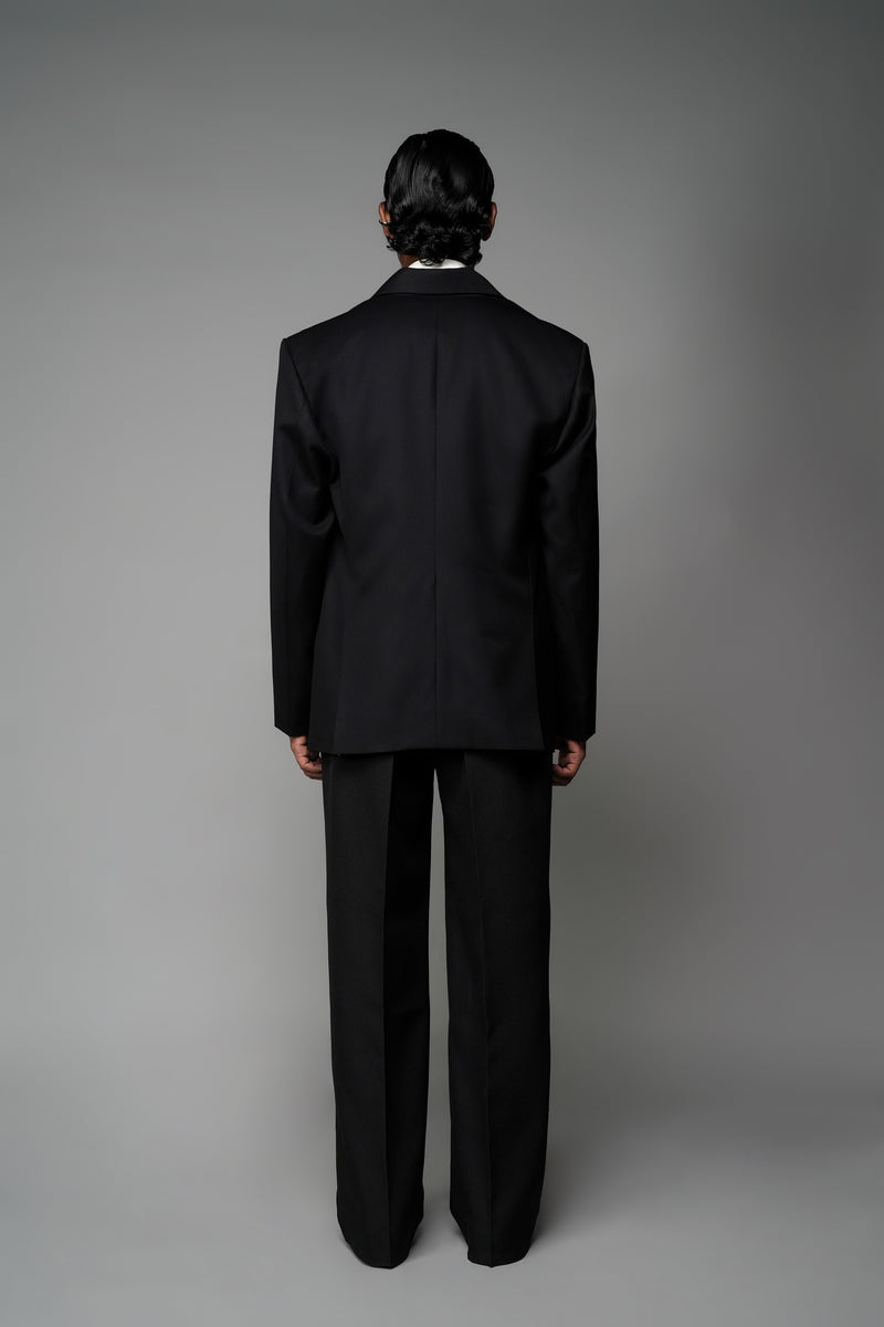 ROSANI The Column blazer in black - sharp-shouldered tailored blazer with wrap front and clean peak lapel, styled with The Eden trouser, back view