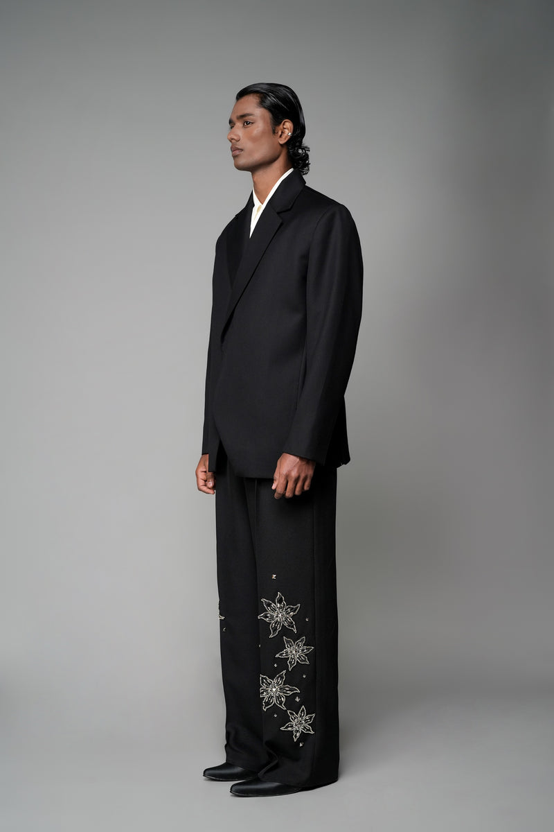 ROSANI The Column blazer in black - sharp-shouldered tailored blazer with wrap front and clean peak lapel, styled with The Eden trouser, front side view