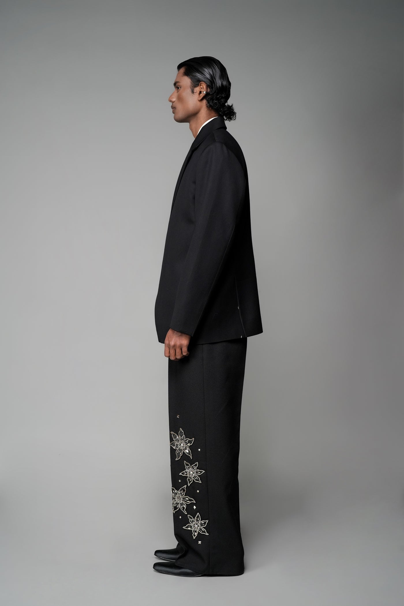 ROSANI The Column blazer in black - sharp-shouldered tailored blazer with wrap front and clean peak lapel, styled with The Eden trouser, side view