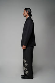 ROSANI The Column blazer in black - sharp-shouldered tailored blazer with wrap front and clean peak lapel, styled with The Eden trouser, side view