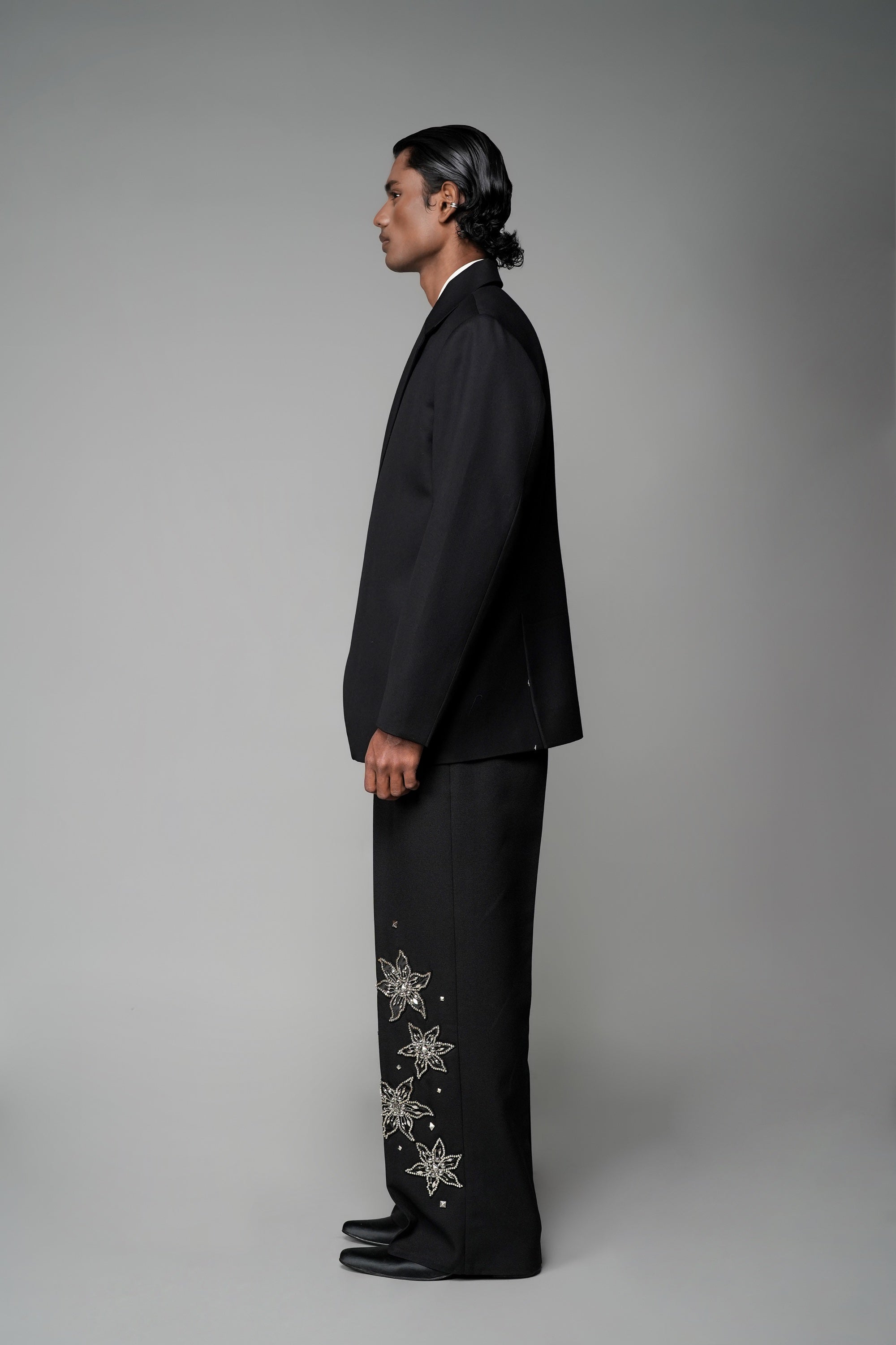 ROSANI The Column blazer in black - sharp-shouldered tailored blazer with wrap front and clean peak lapel, styled with The Eden trouser, side view