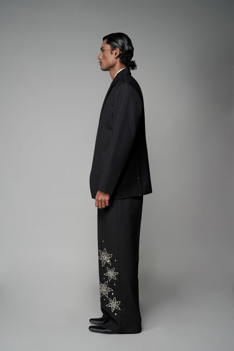 ROSANI The Column blazer in black - sharp-shouldered tailored blazer with wrap front and clean peak lapel, styled with The Eden trouser, side view