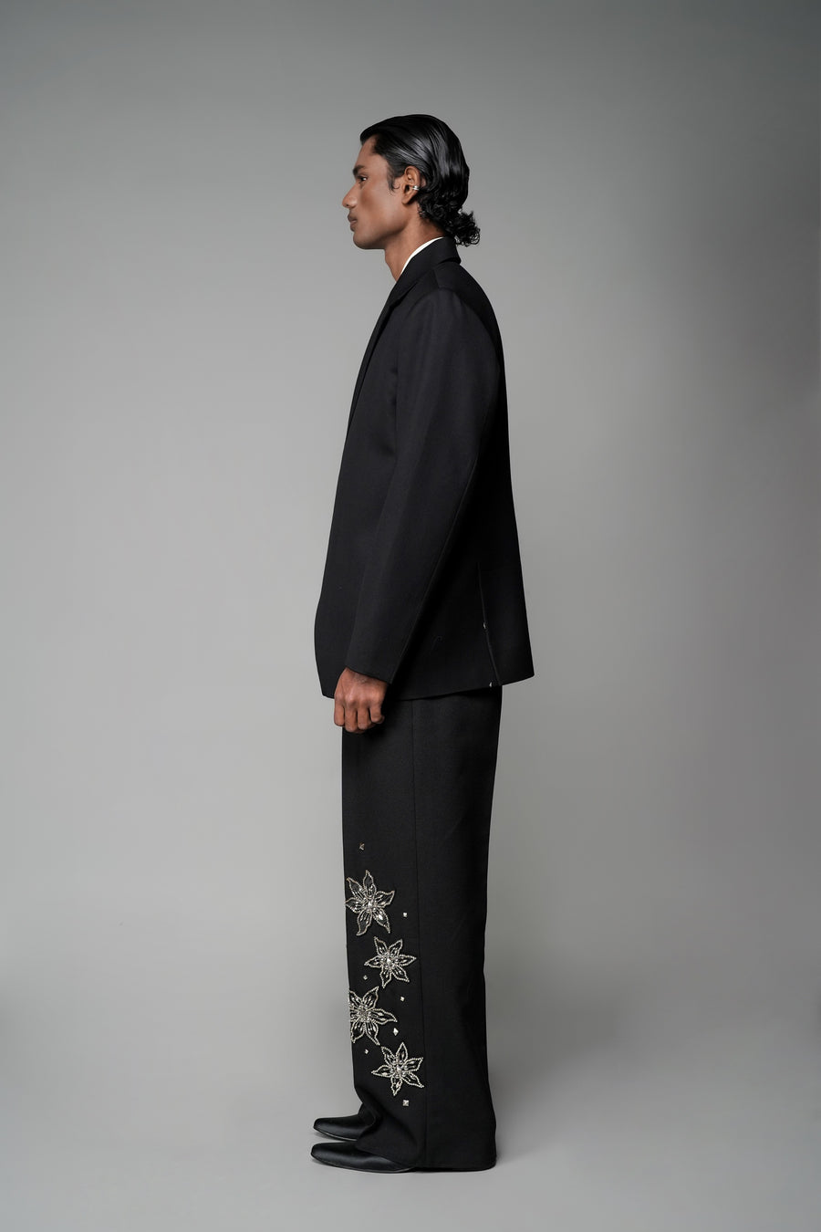 ROSANI The Column blazer in black - sharp-shouldered tailored blazer with wrap front and clean peak lapel, styled with The Eden trouser, side view