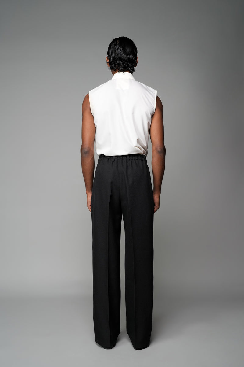 ROSANI The Eden trouser in black - mid-rise tailored trousers with straight-leg fit, and metallic embroidered stars on the legs, back view with elastic waistband