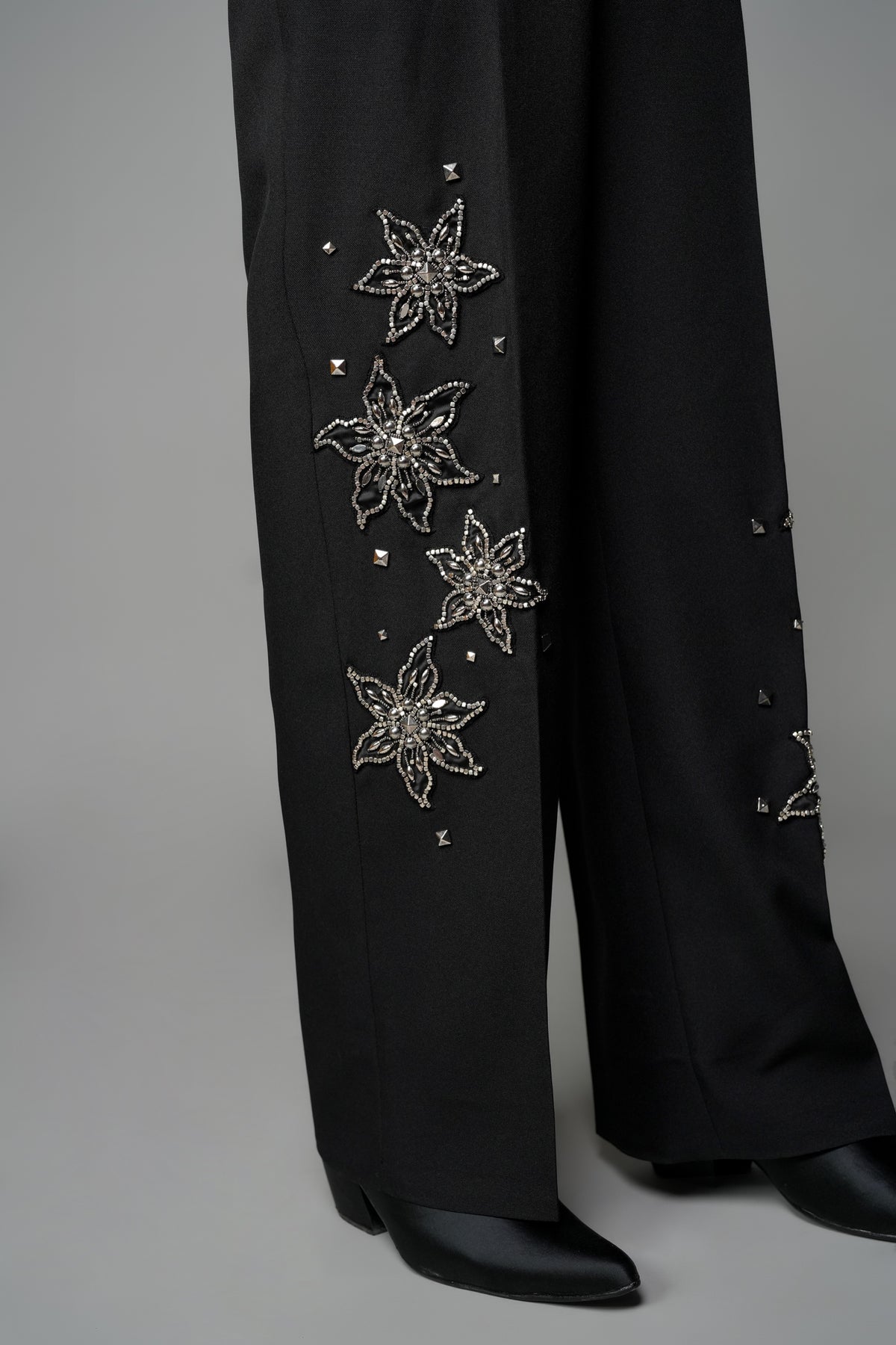 ROSANI The Eden trouser in black - mid-rise tailored trousers with straight-leg fit and metallic embroidered stars on the legs, detail view