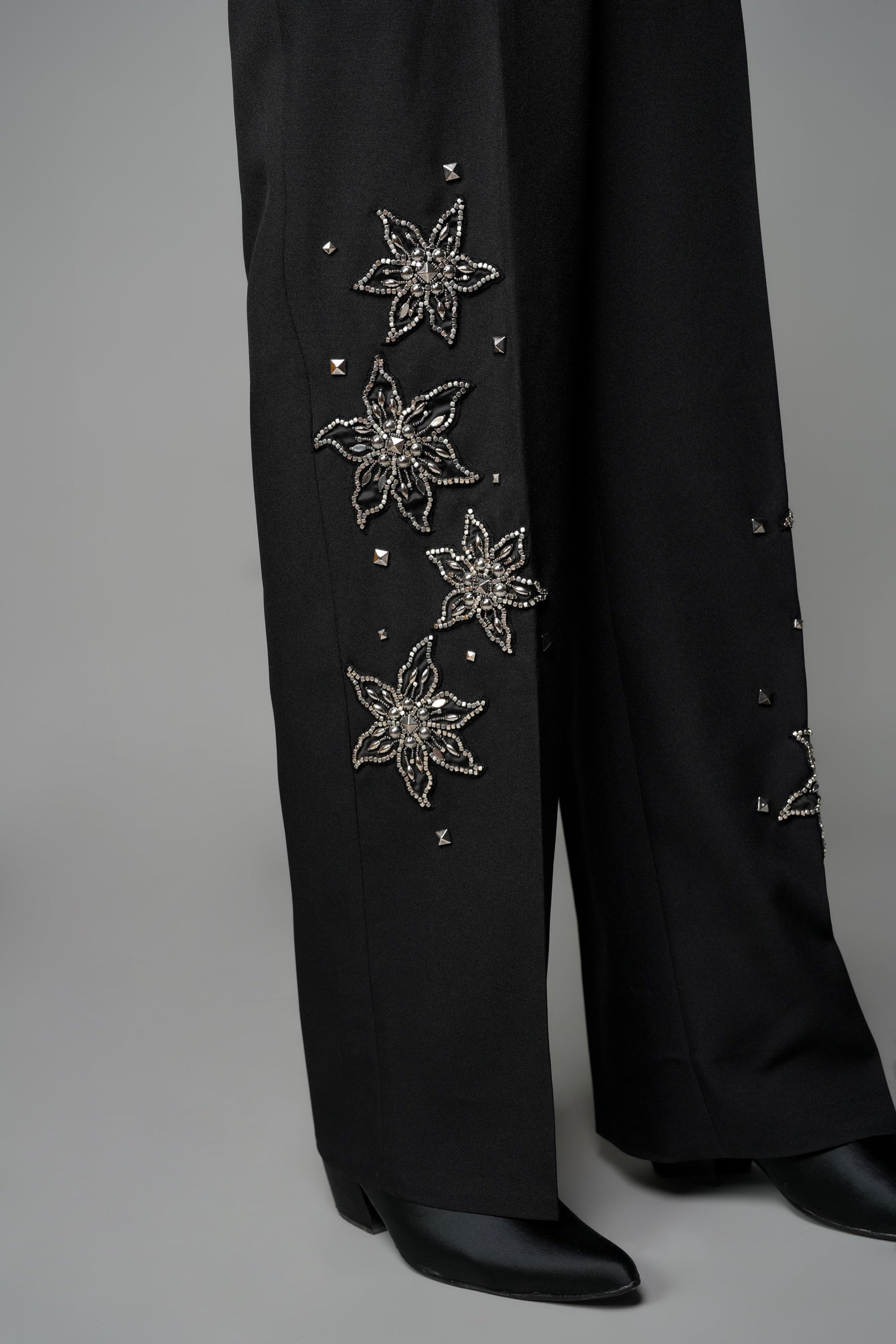ROSANI The Eden trouser in black - mid-rise tailored trousers with straight-leg fit and metallic embroidered stars on the legs, detail view