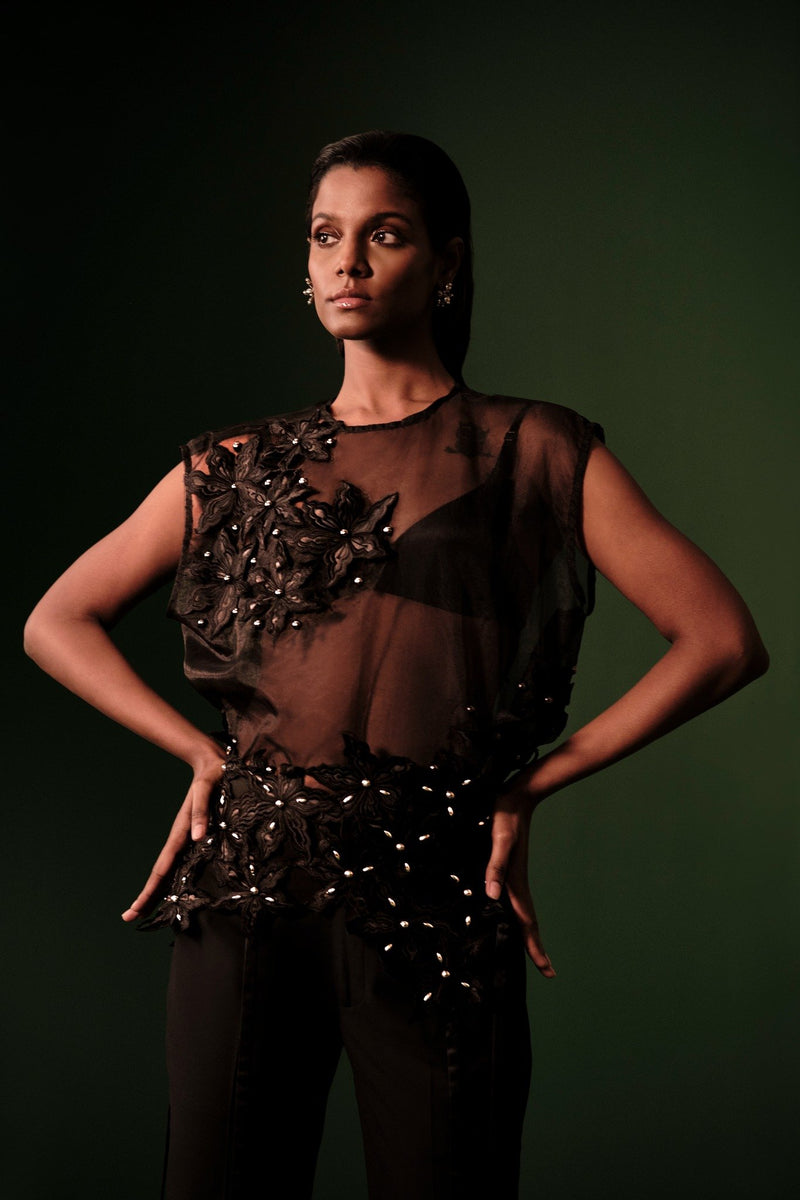 ROSANI The Fern top in black - sheer sleeveless top with floral applique detailing and asymmetric placement, front editorial view