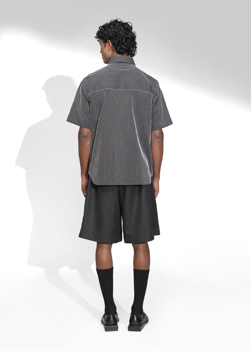 ROSANI The Frame Shirt in white, short-sleeve button-up with subtle pinstripes, styled with black tailored shorts, back view