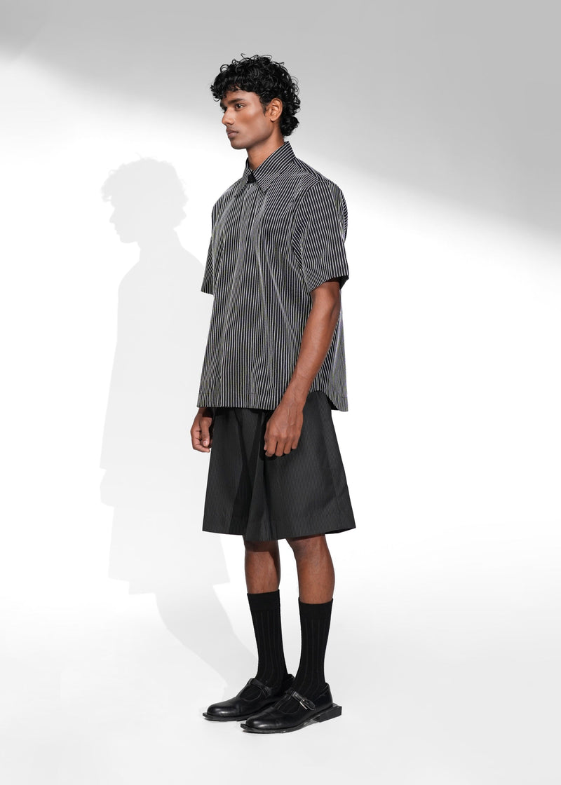 ROSANI The Frame Shirt in white, short-sleeve button-up with subtle pinstripes, styled with black tailored shorts, front side view