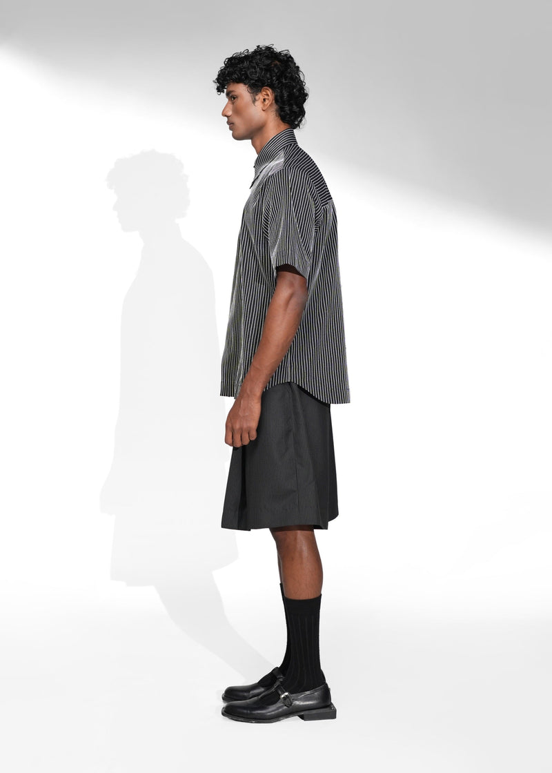 ROSANI The Frame Shirt in white, short-sleeve button-up with subtle pinstripes, styled with black tailored shorts, side view