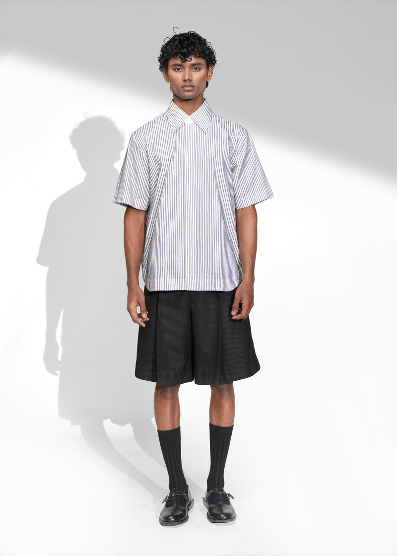 ROSANI The Frame Shirt in white, short-sleeve button-up with subtle pinstripes, styled with black tailored shorts, front view