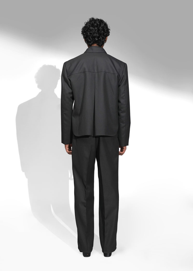 ROSANI The Haven Jacket in pinstripe black, textured zip-front jacket styled with matching trousers and tie, back view