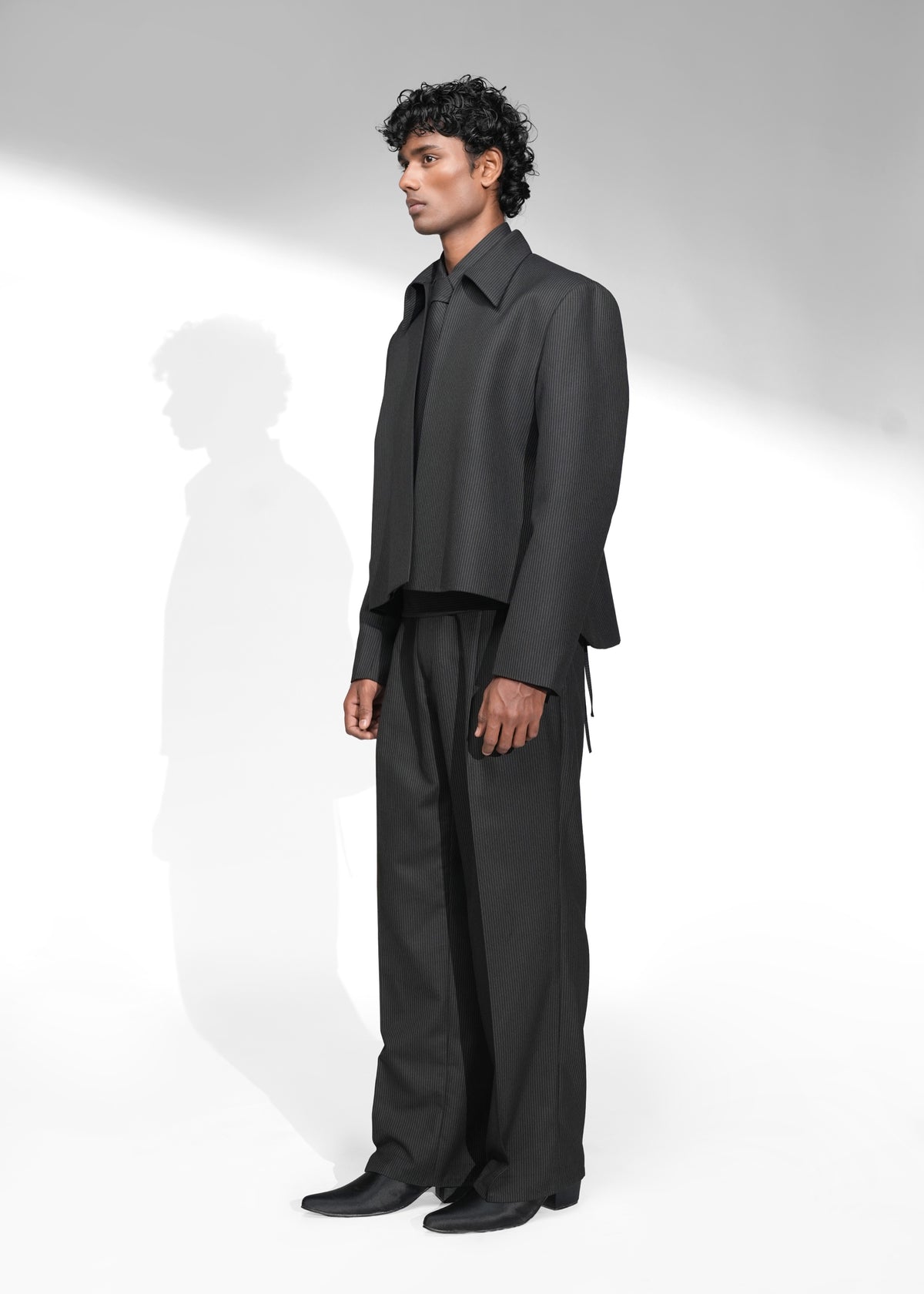 ROSANI The Haven jacket in black pinstripe - structured evening jacket with open side seams, front side view
