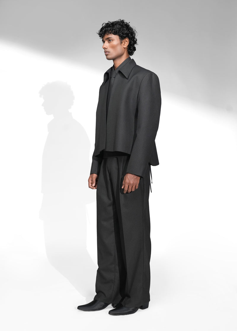 ROSANI The Haven Jacket in pinstripe black, textured zip-front jacket styled with matching trousers and tie, front side view