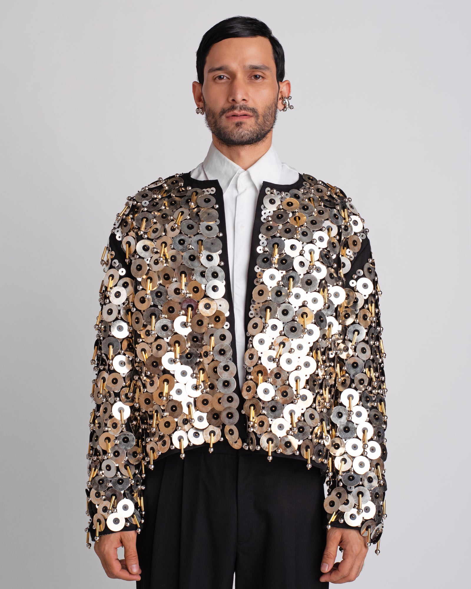 ROSANI The Jase jacket in black and silver. Fully hand-embroidered showstopper jacket with metallic discs, beads and tube detailing. ANIMA and ANIMUS collection, front view.