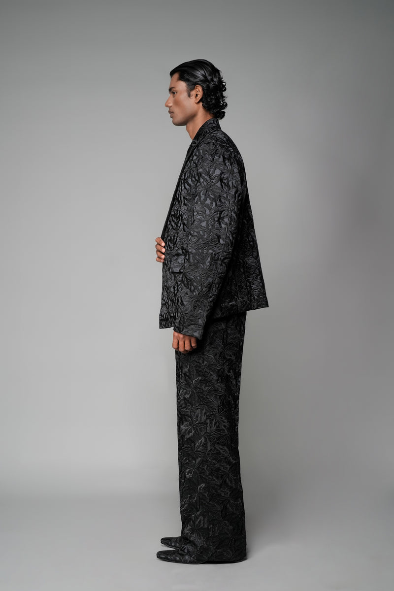 ROSANI The Lumen blazer in black - textured jacquard blazer styled with matching trousers, side view