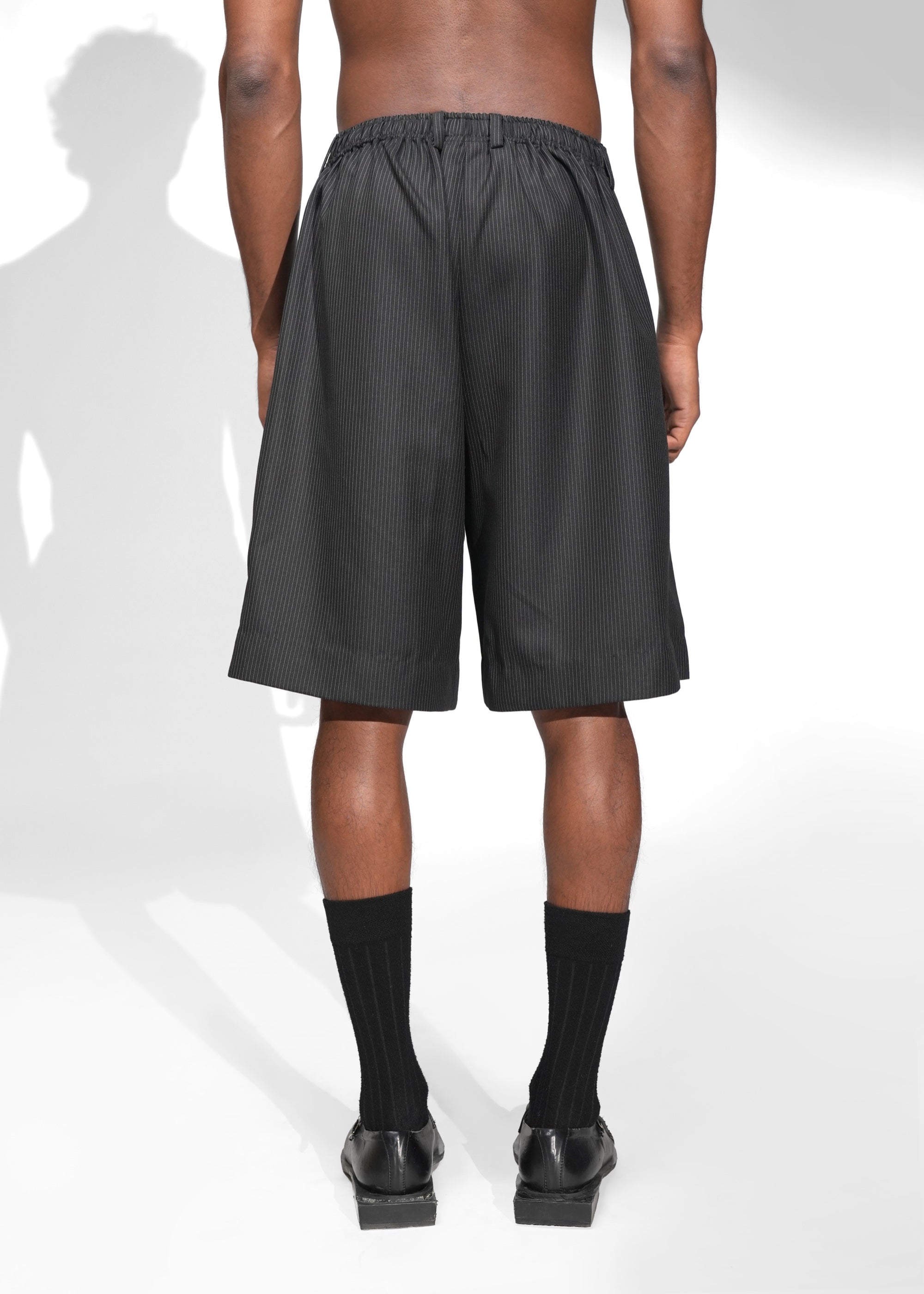 ROSANI The Refuge shorts in pinstripe black - tailored wide-leg shorts with front pleats and back elastic waistband, back view