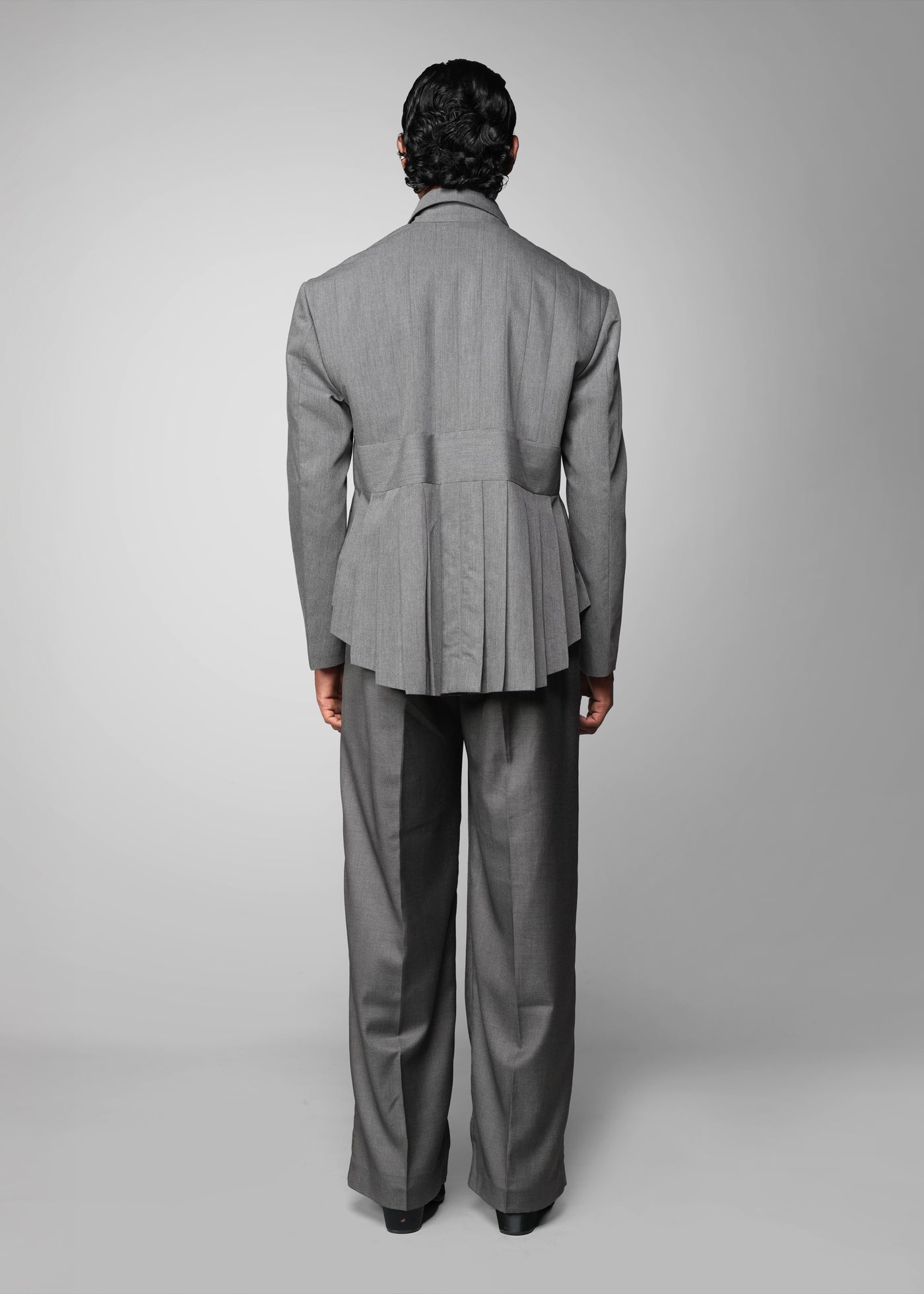 ROSANI The Sanctum jacket in grey - pleated padded blazer with front clasps closure, back view styled with matching trouser