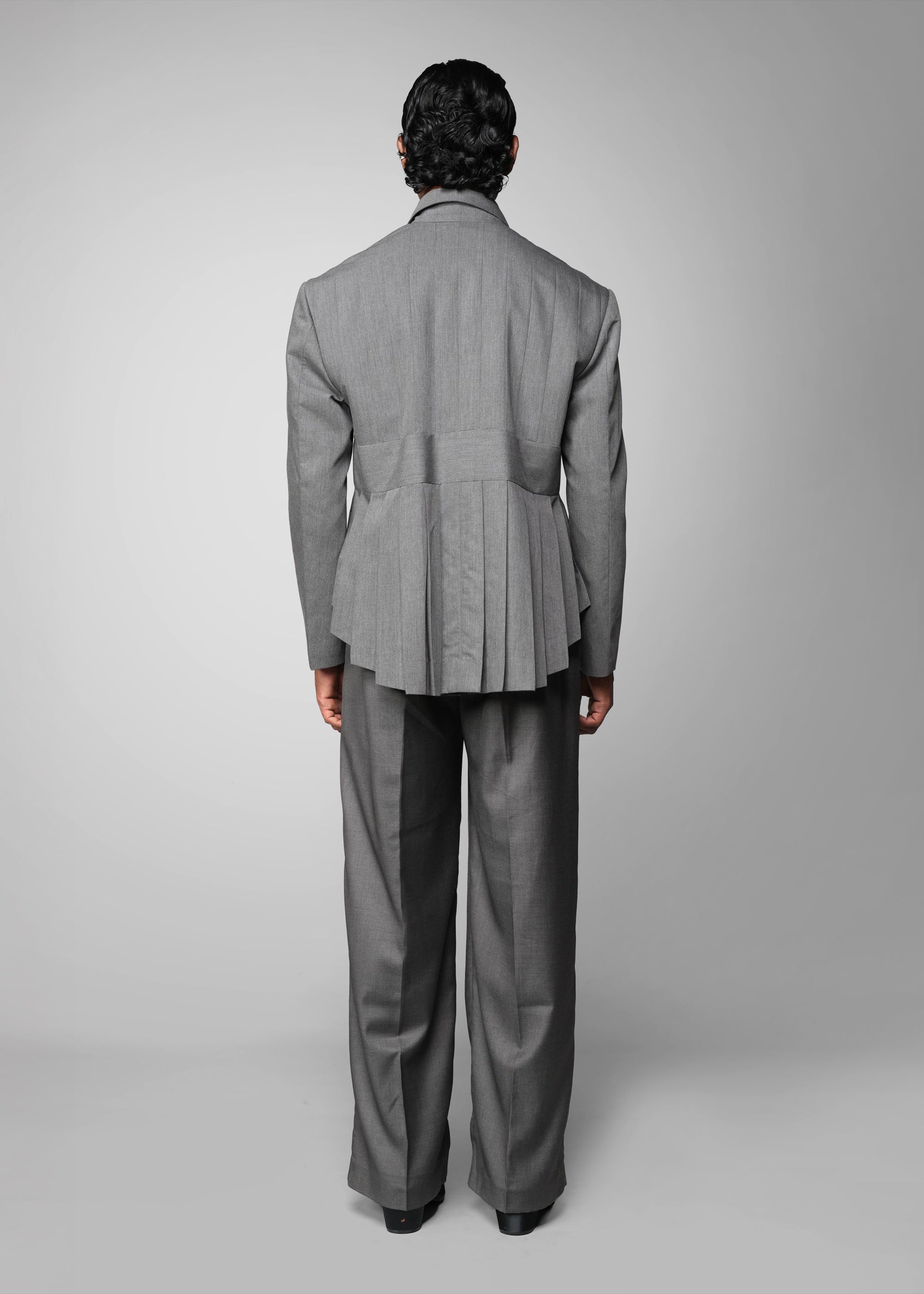 ROSANI The Sanctum jacket in grey - pleated padded blazer with front clasps closure, back view styled with matching trouser