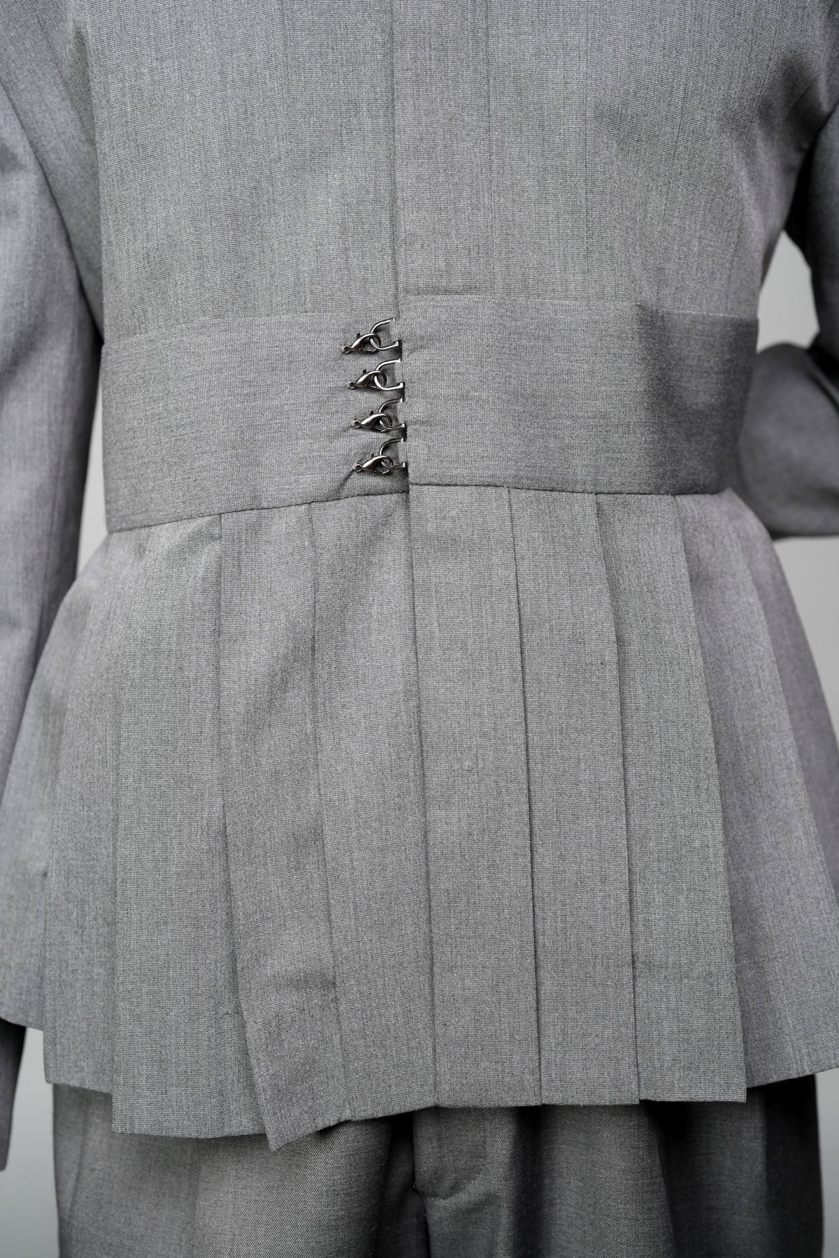 ROSANI The Sanctum jacket in grey - pleated shoulder and clasps closure detail, close-up