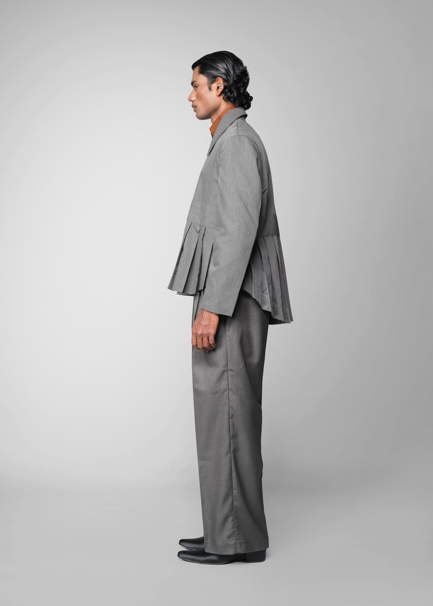 ROSANI The Sanctum jacket in grey - pleated padded blazer with front clasps closure, side view styled with matching trouser
