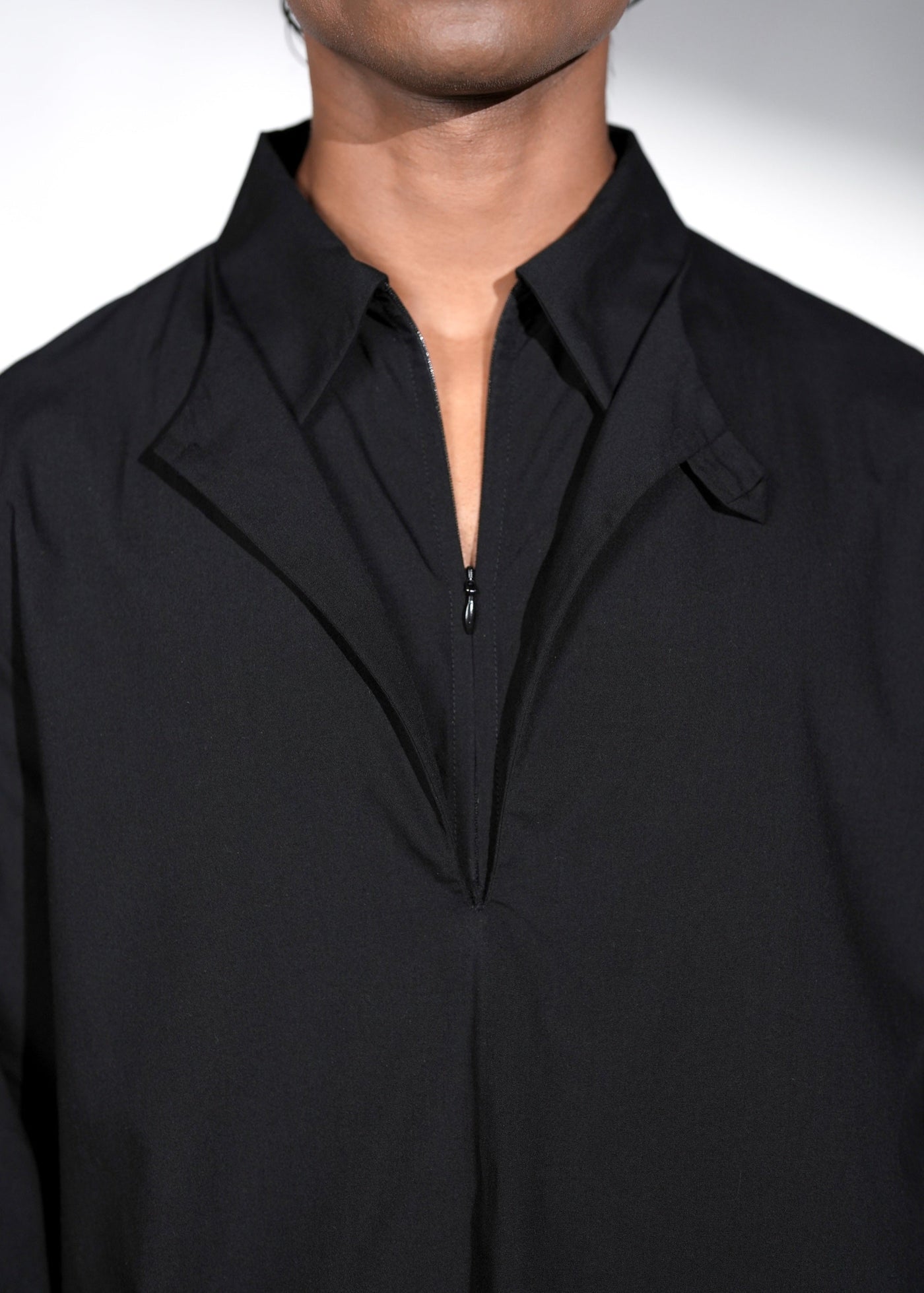 ROSANI The Serenity shirt in black - layered collar detail showing round neck beneath zip collar, close-up