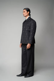 ROSANI The Solum jacket in black - padded blazer with circular metallic embellishment, front side view