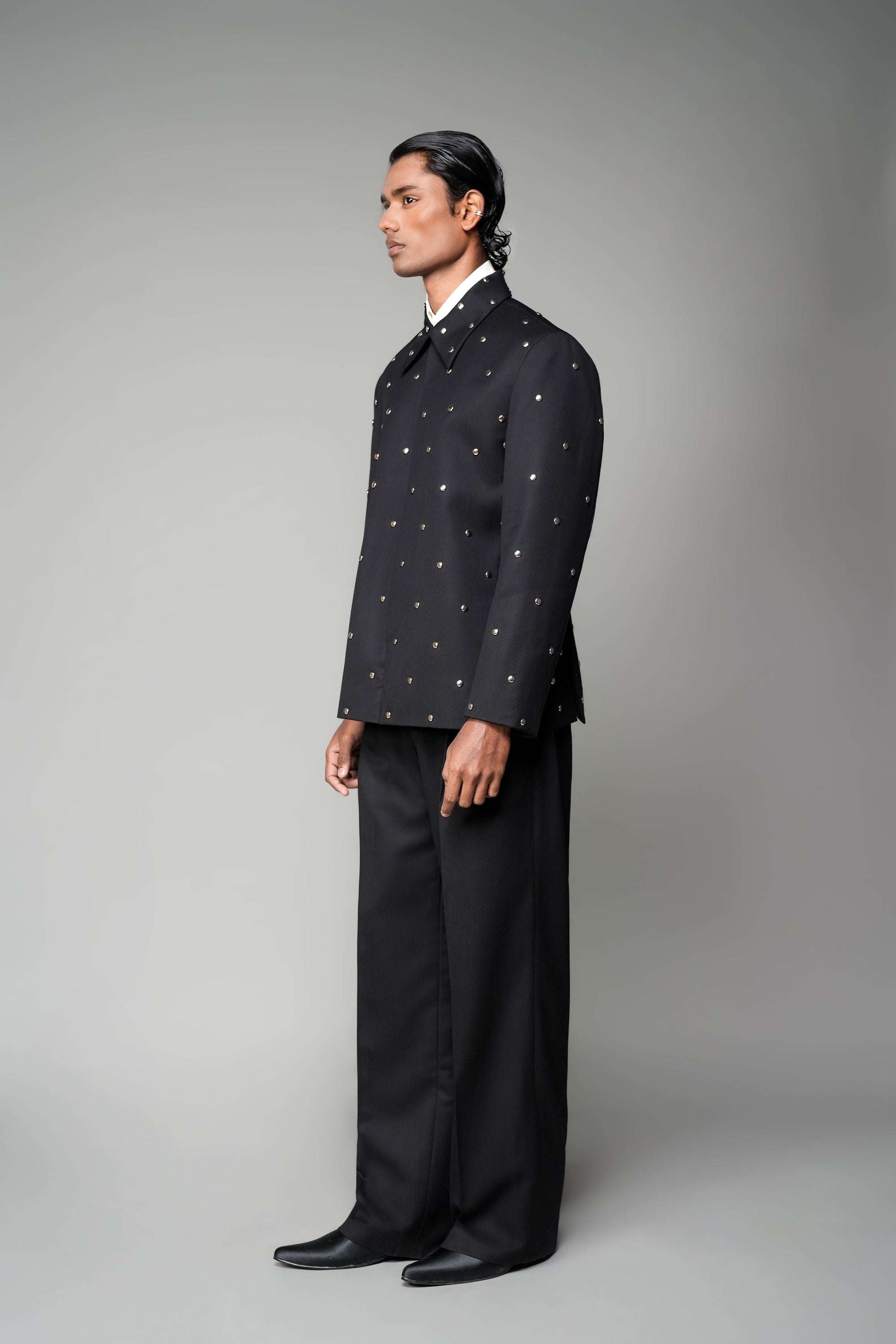 ROSANI The Solum jacket in black - padded blazer with circular metallic embellishment, front side view