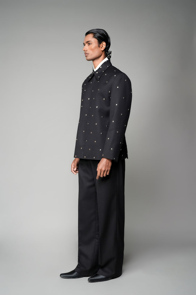 ROSANI The Solum jacket in black - padded blazer with circular metallic embellishment, front side view
