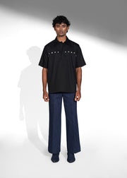 ROSANI The Vaulta shirt in black - half-sleeve cotton shirt with metallic button shoulder joint detail, front view