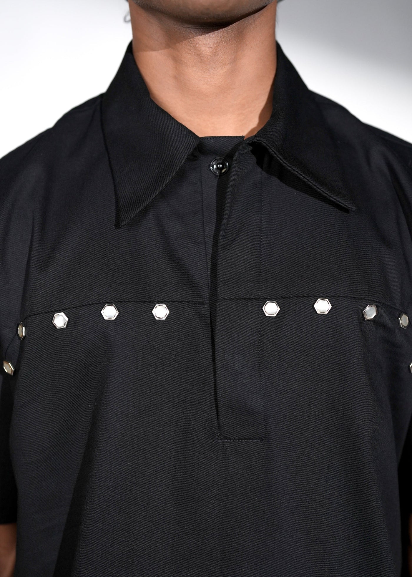 ROSANI The Vaulta shirt in black - metallic button shoulder joint detail, close-up