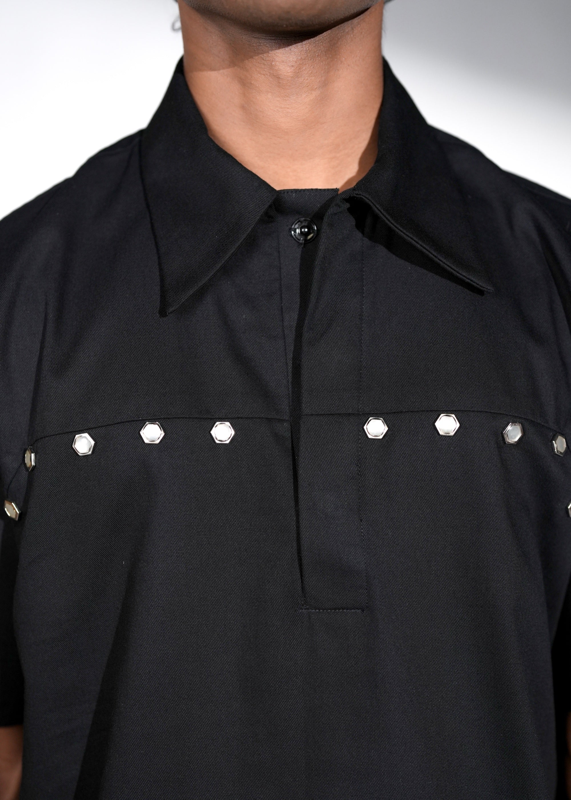 ROSANI The Vaulta shirt in black - metallic button shoulder joint detail, close-up