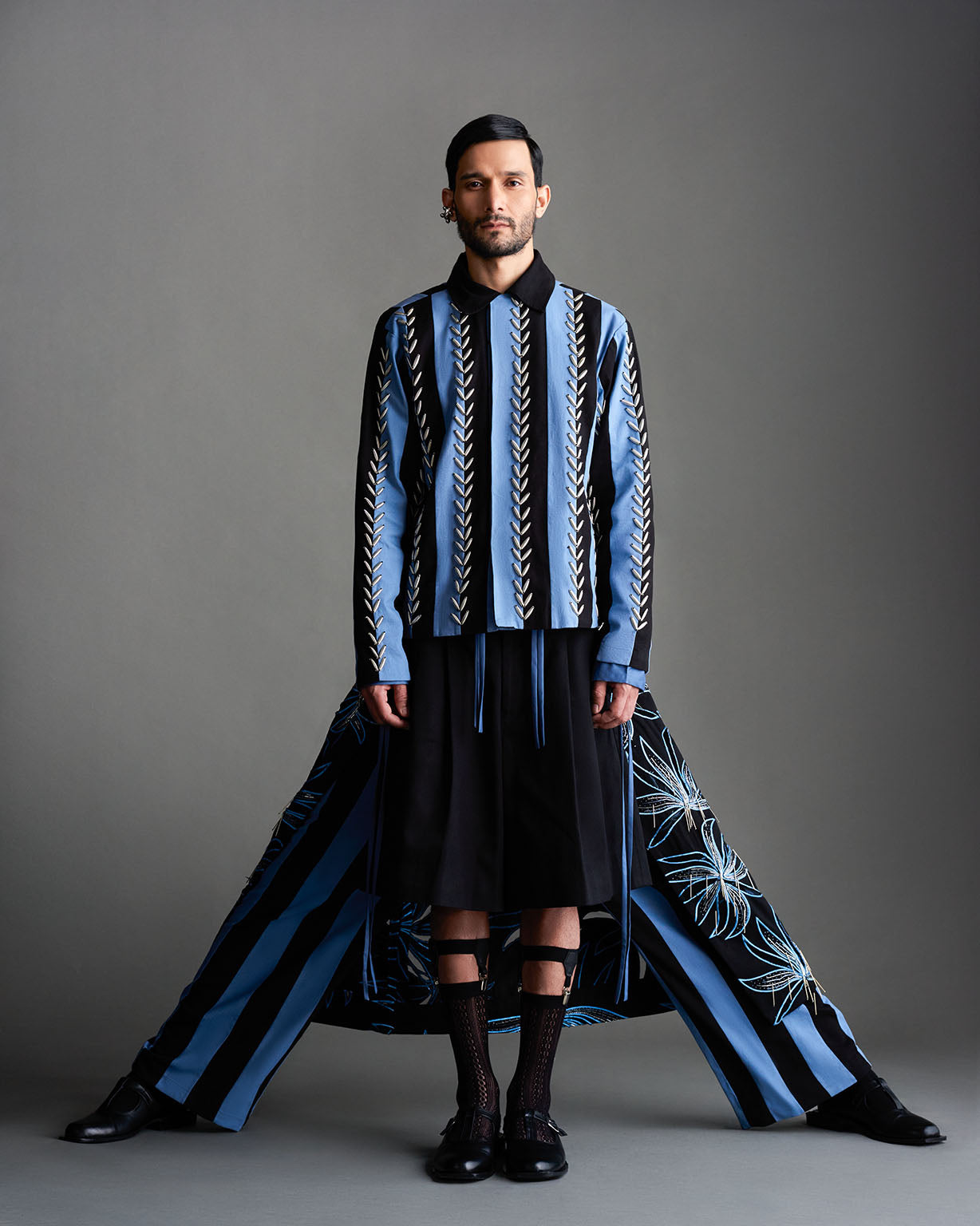 ROSANI The Ainsley jacket in black - relaxed workwear jacket with blue vertical woven pattern and contrast collar, styled with wide-leg striped trousers, front view (ANIMA & ANIMUS campaign)