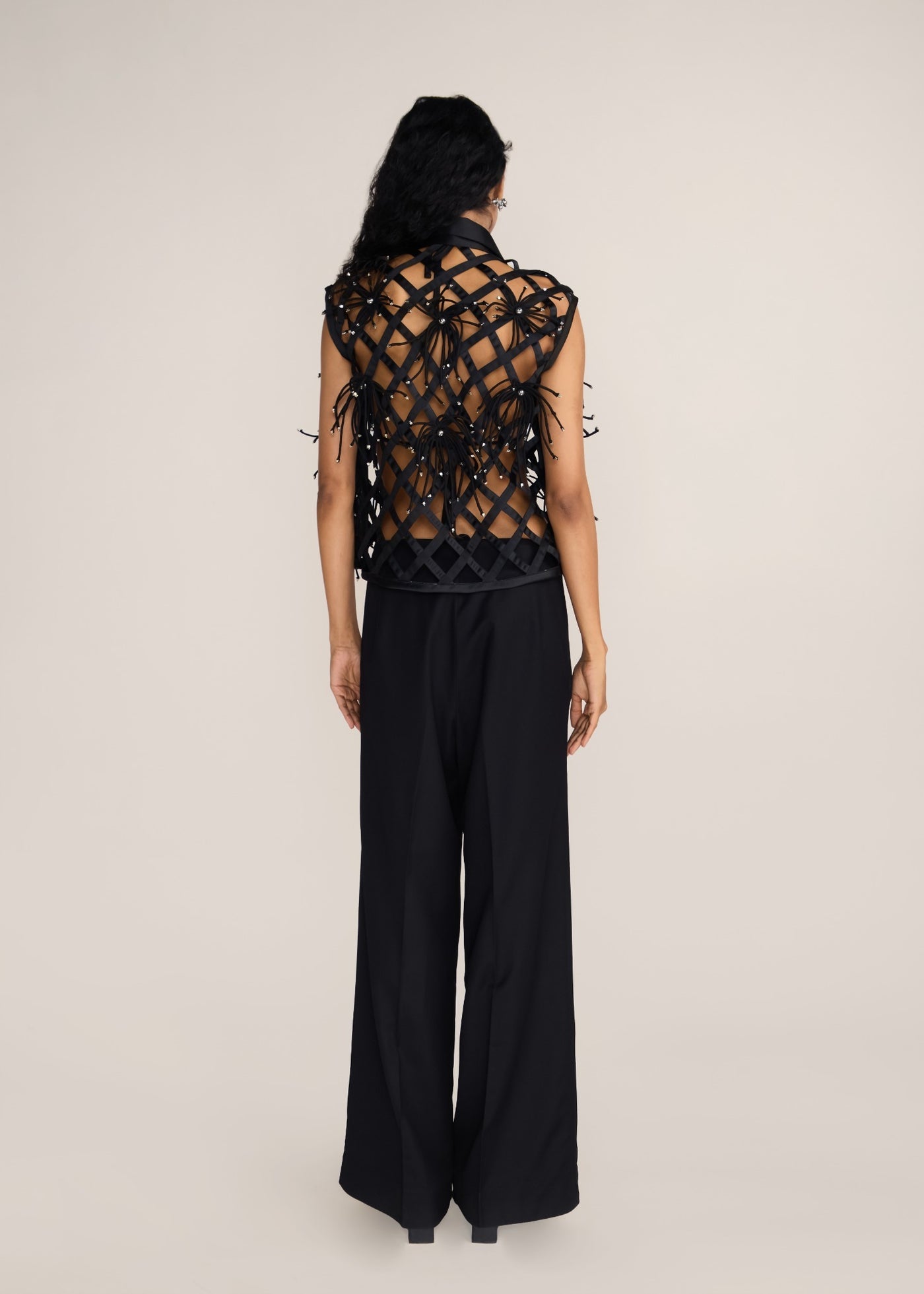 ROSANI The Aether vest in obsidian - obsidian hand-woven strip vest with botanical metallic embroidery, side view