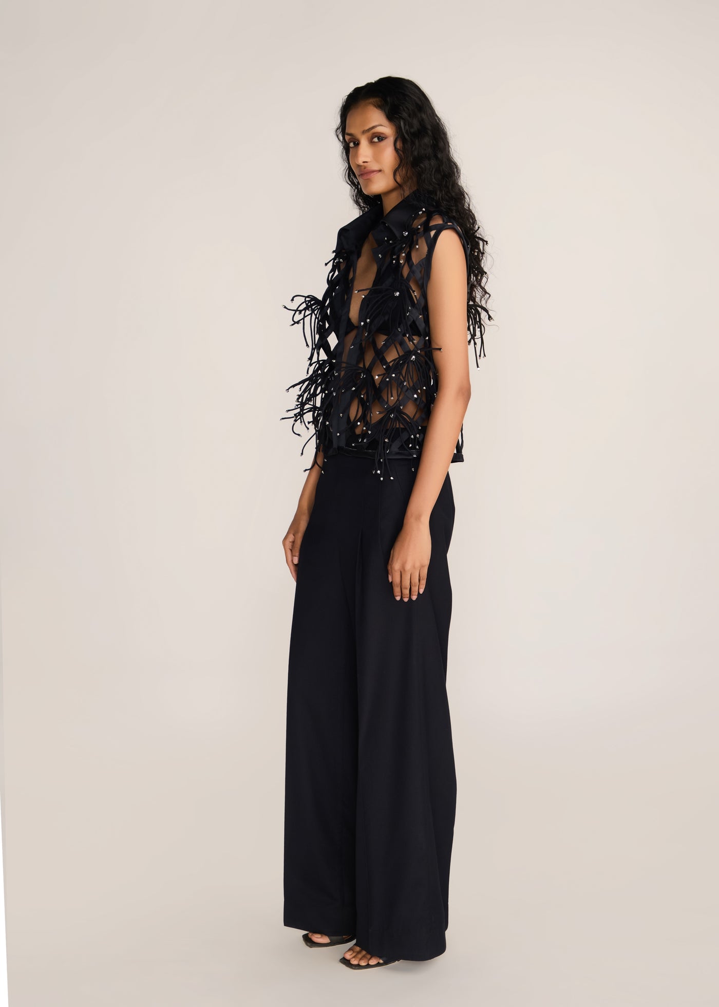 ROSANI The Aether vest in obsidian - obsidian hand-woven strip vest with botanical metallic embroidery, side view